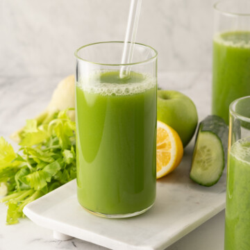 Glasses of bright green, healthy cucumber, celery vegetables juice.