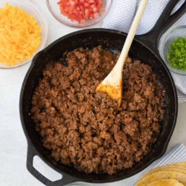 Savory spiced taco meat in a black cast iron skillet ready for tacos.
