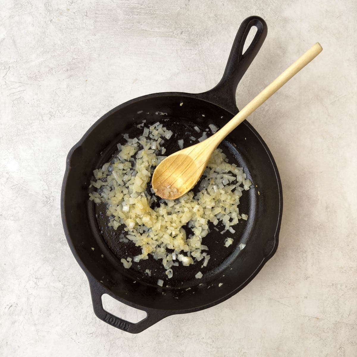 Sautéing chopped onions in a cast iron skillet. 