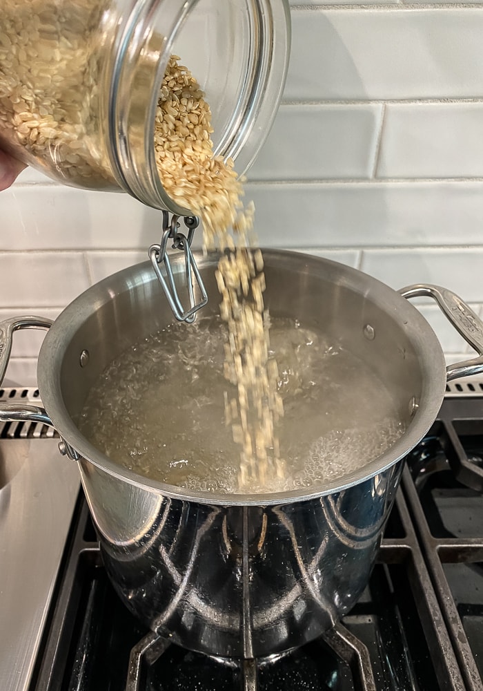 pouring rice into pot | afoodcentriclife.com