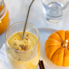 creamy orange pumpkin smoothie in a glass