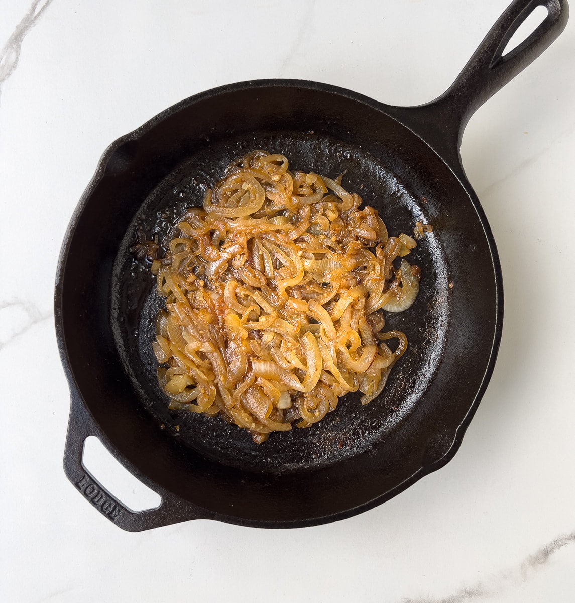 Caramelized onions in black pan.
