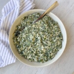 Ricotta cheese spinach filling in a bowl on the counter.