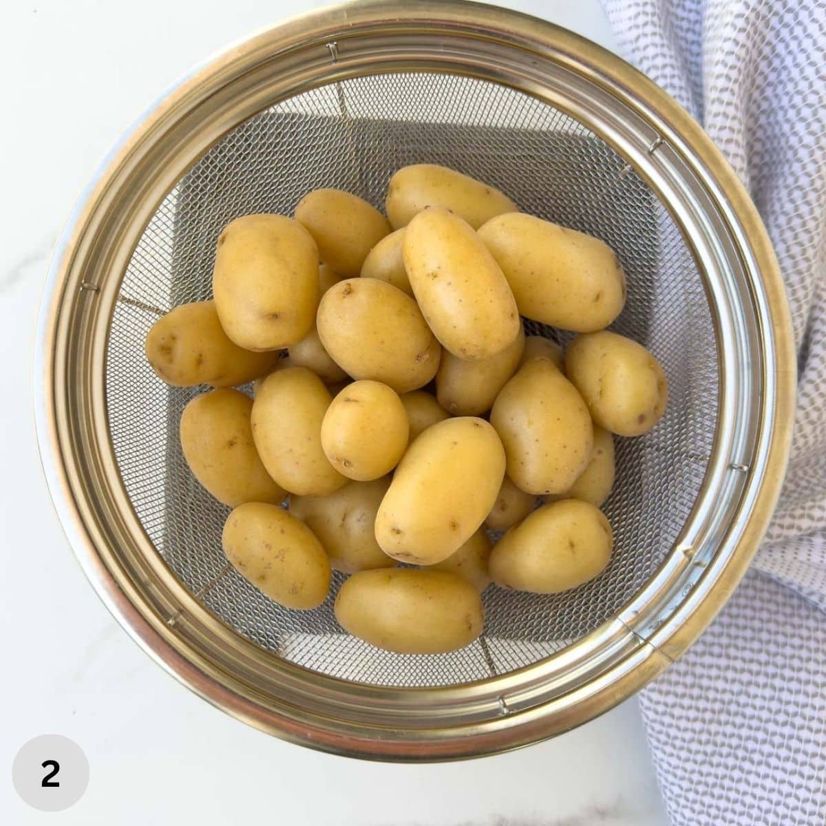 Baby gold potatoes in a colander after cooking.