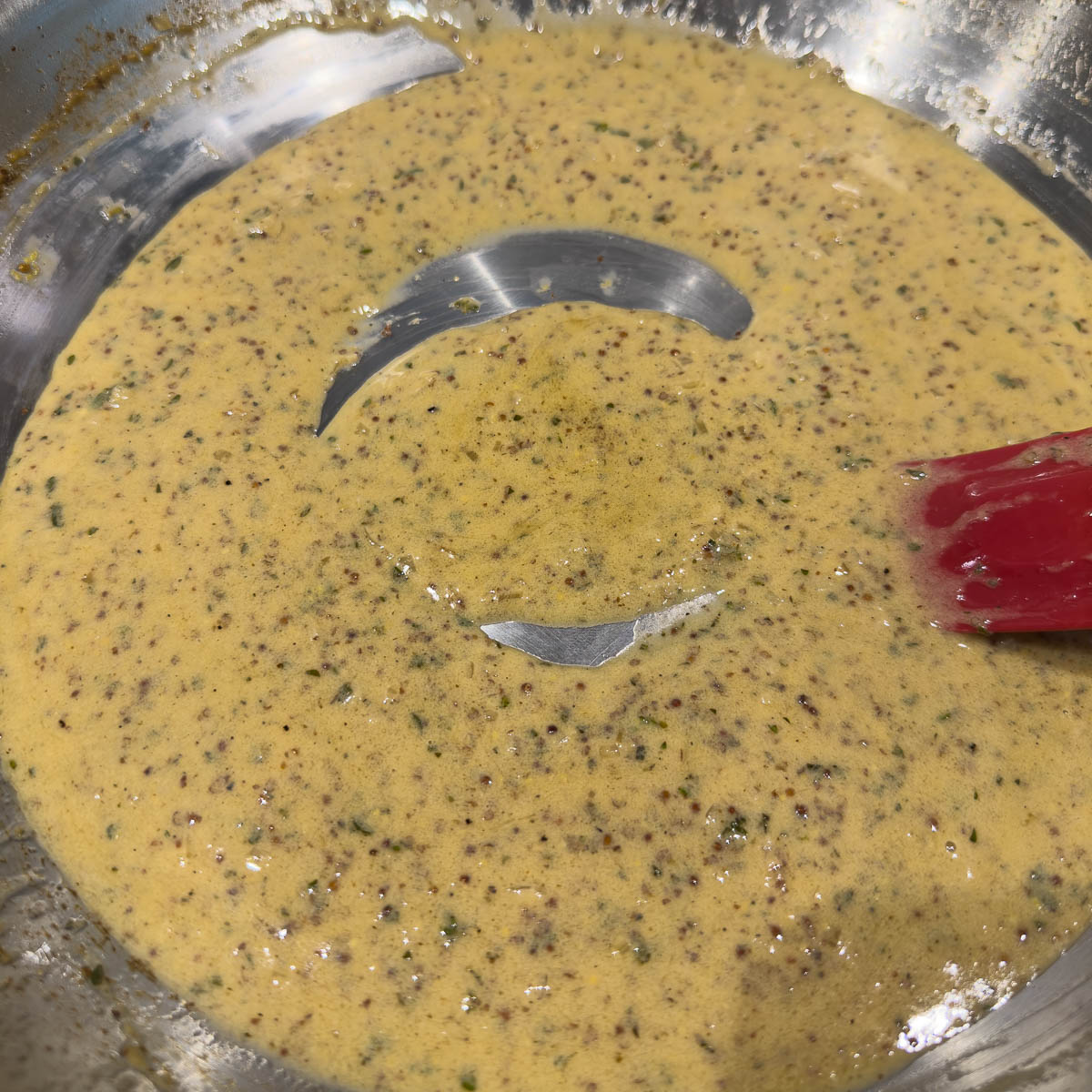 Thickened mustard cream sauce finishing in the pan, ready to serve. 