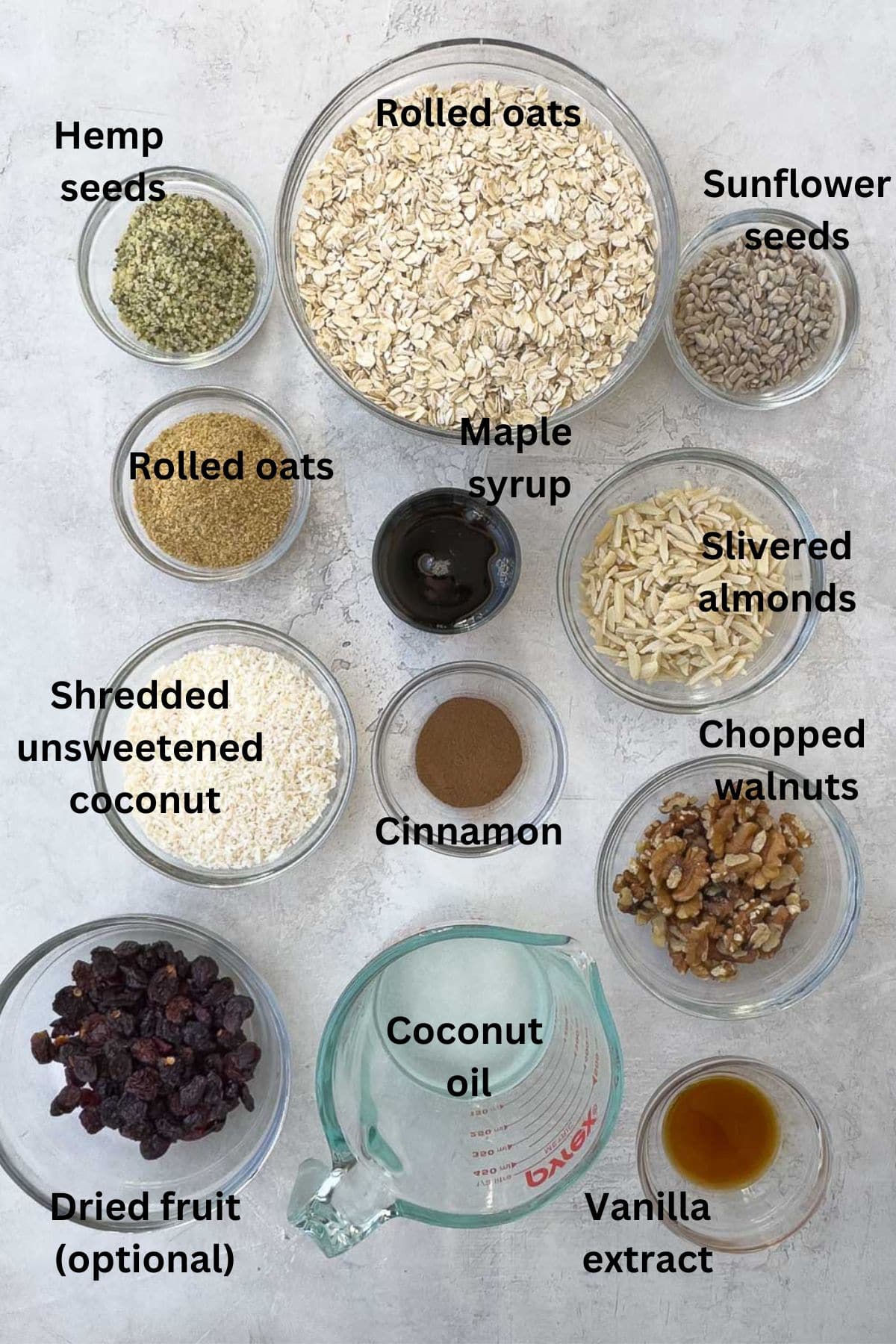 Ingredients for healthy homemade granola in bowls ready to start baking. 
