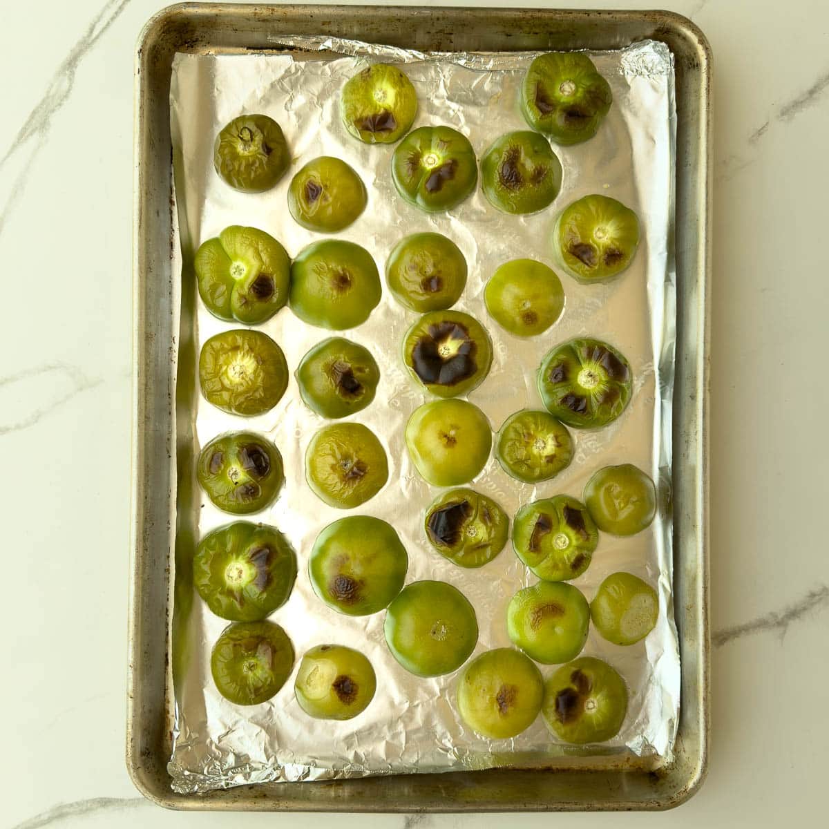 Green tomatillos after broiling with browned spots.