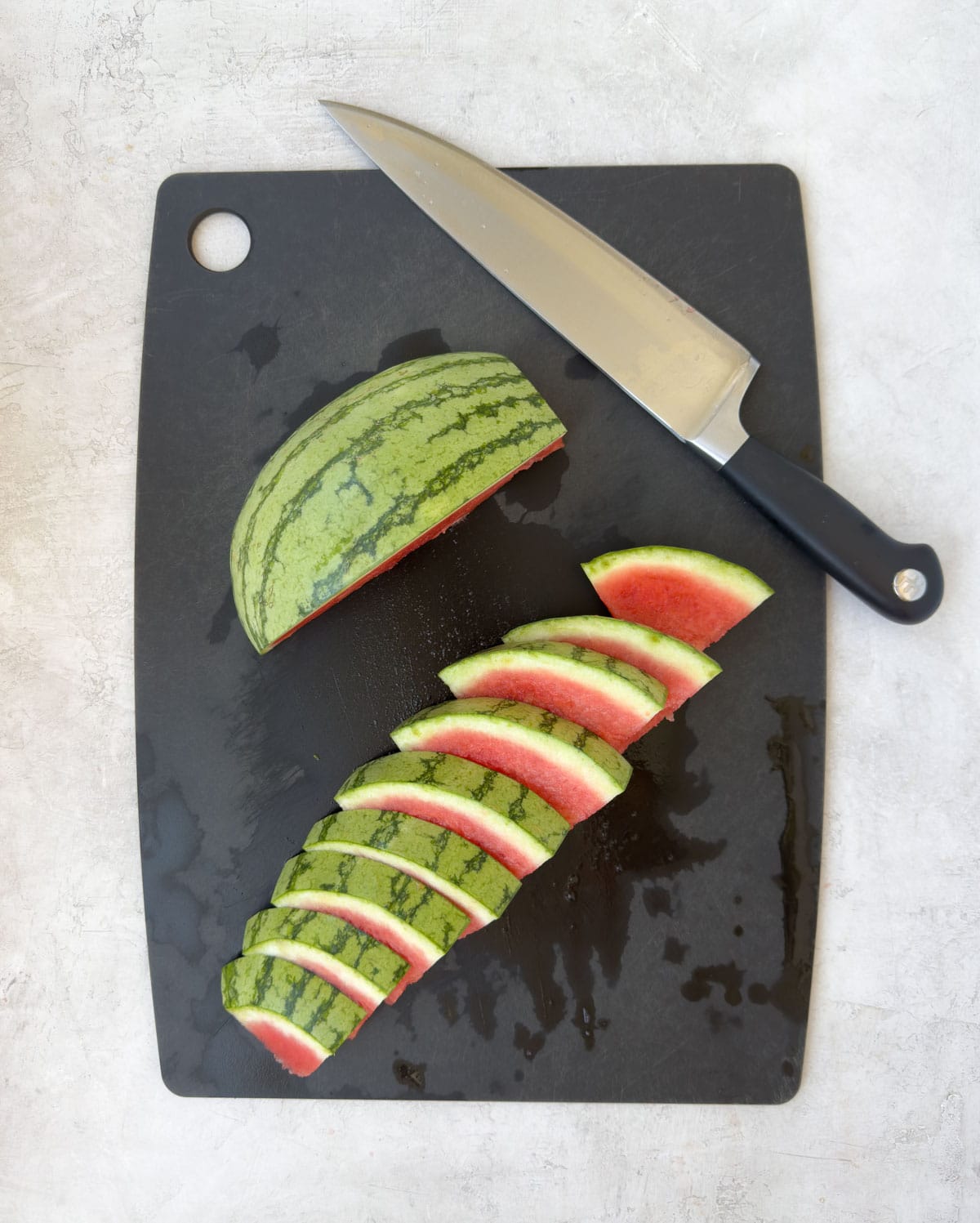 Showing how to cut watermelon slices from a quarter melon. 