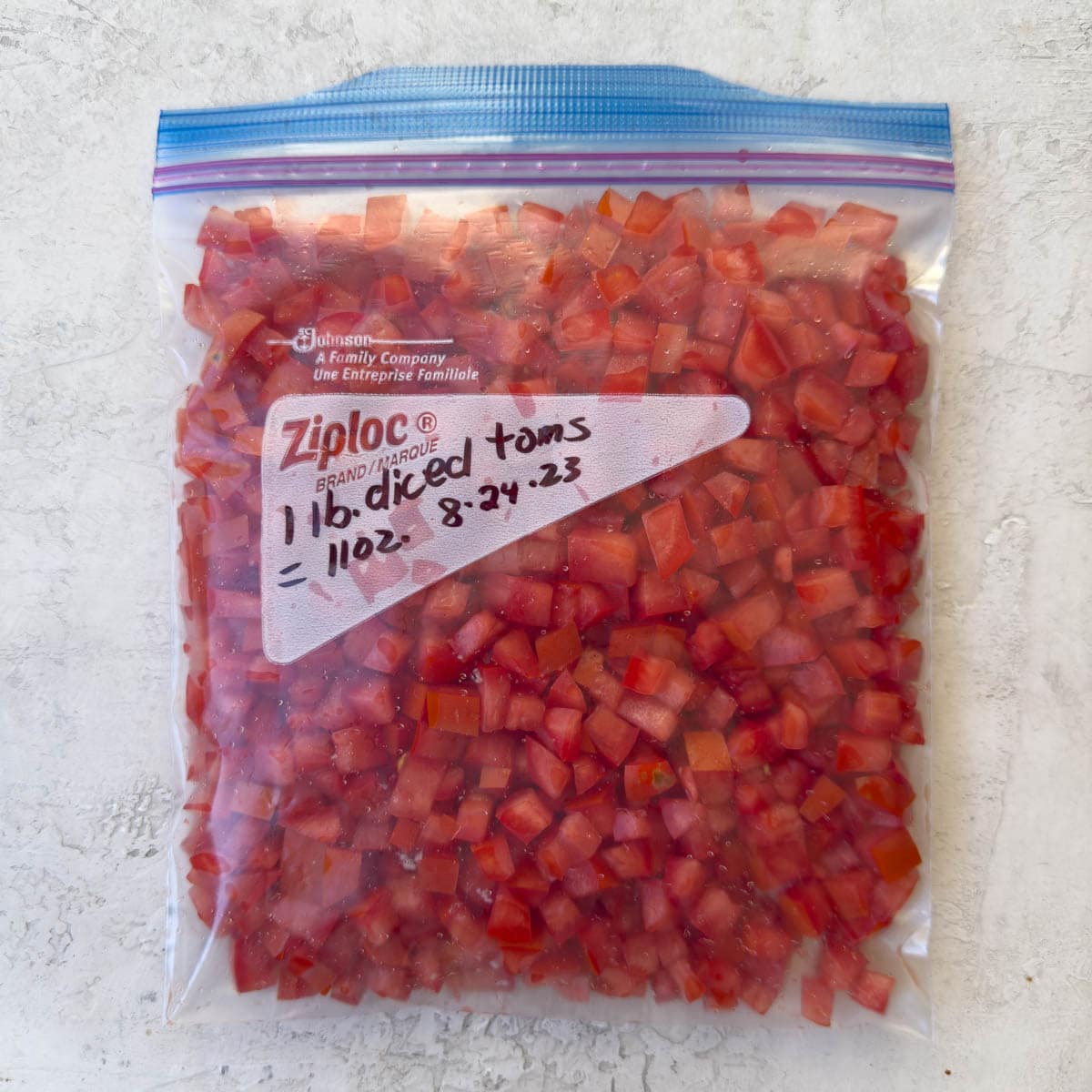 A zip bag of fresh diced tomatoes ready for the freezer. 