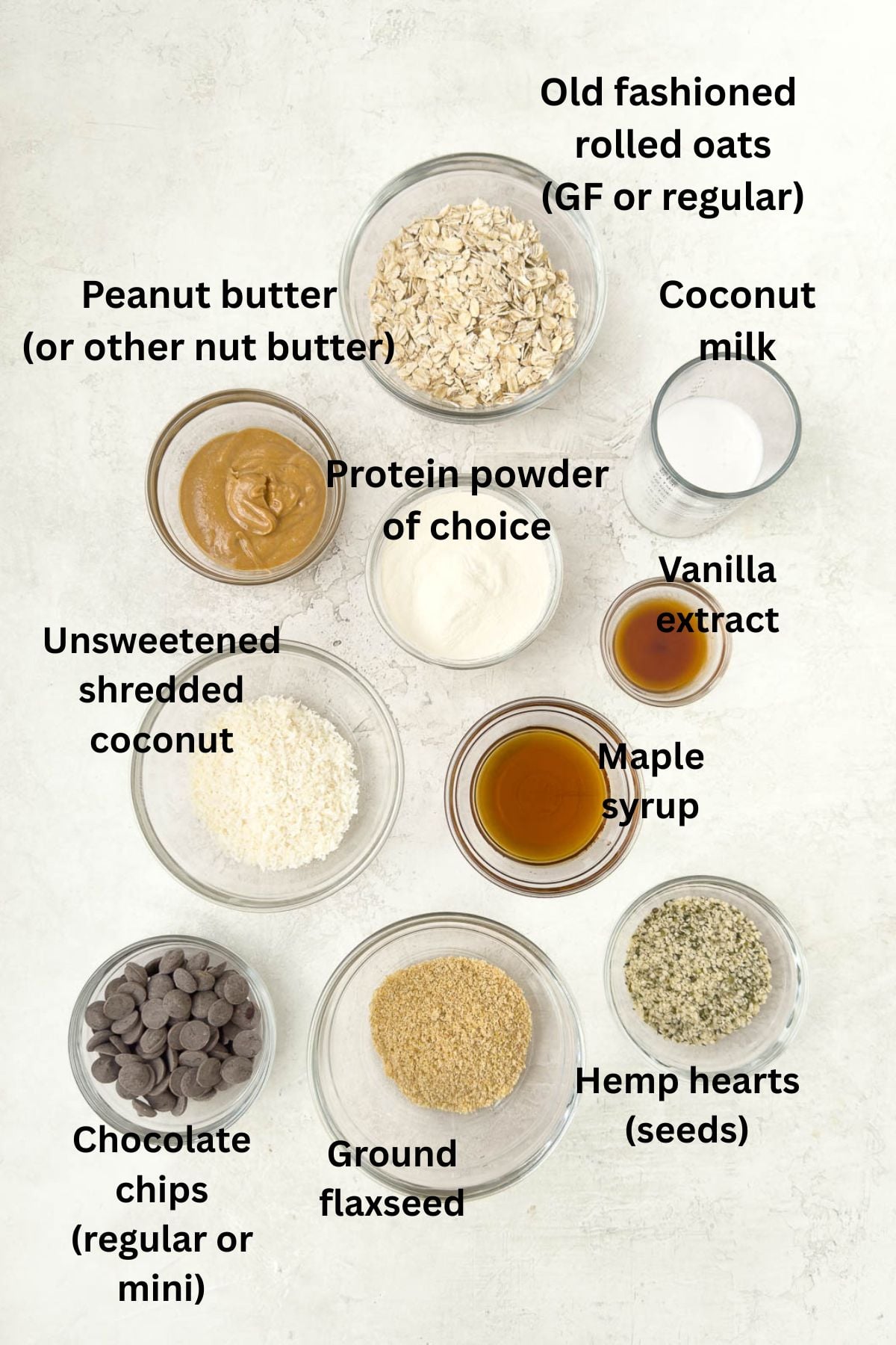 Ingredients for peanut butter protein balls in glass prep bowls.