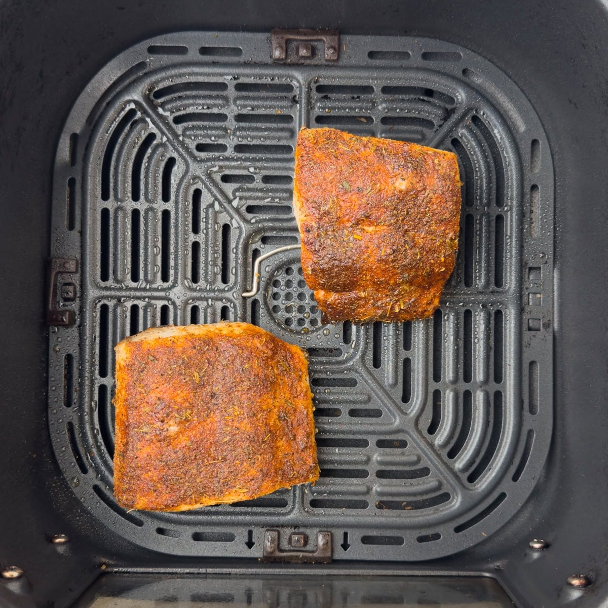 Air fryer mahi mahi with a blackening seasoning in the air fryer basket.