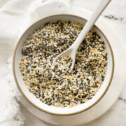 Small bowl of homemade everything but the bagel seasoning with seeds, garlic, and onion.