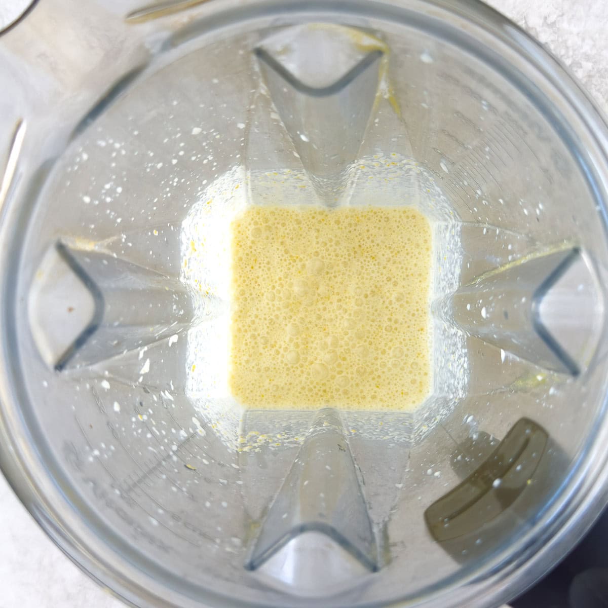 Pureed corn and half and half in a blender from the top down.