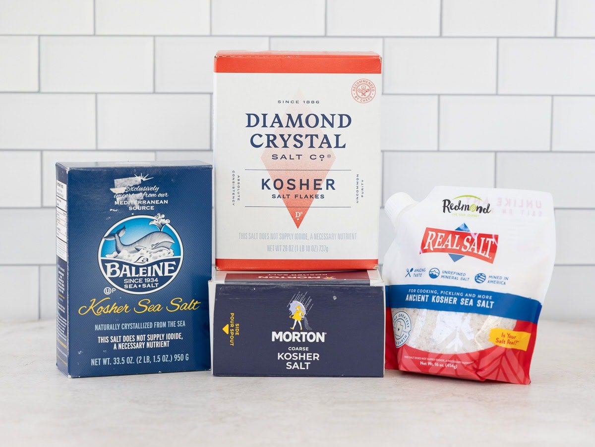 Boxes of different kosher salts for brining on a kitchen counter.