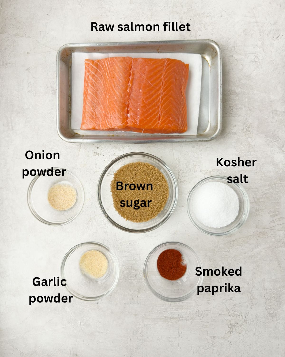 Ingredients for smoked salmon on a gray kitchen counter.