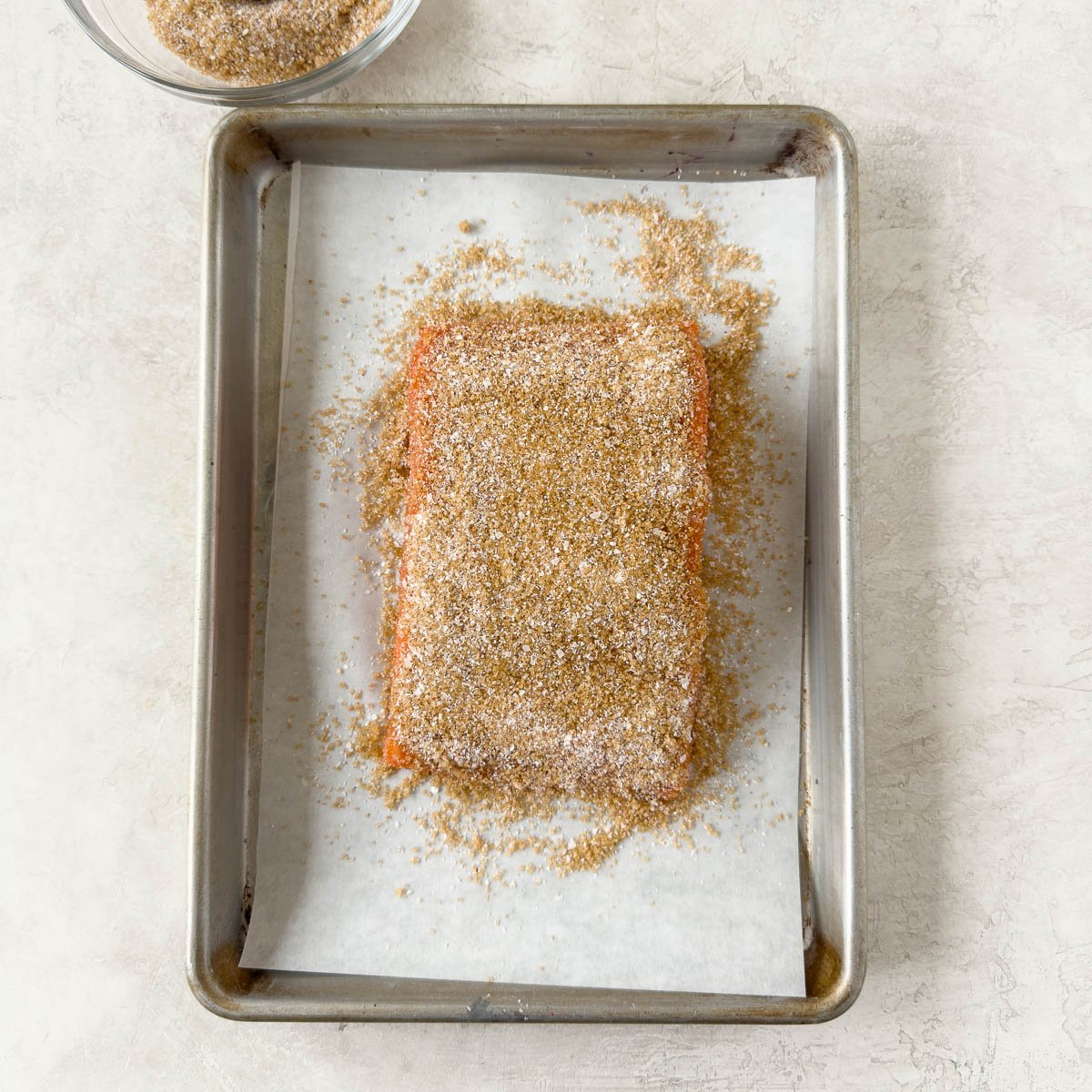 Salmon fillet covered in a smoking cure with bronw sugar, salt, and spices. 