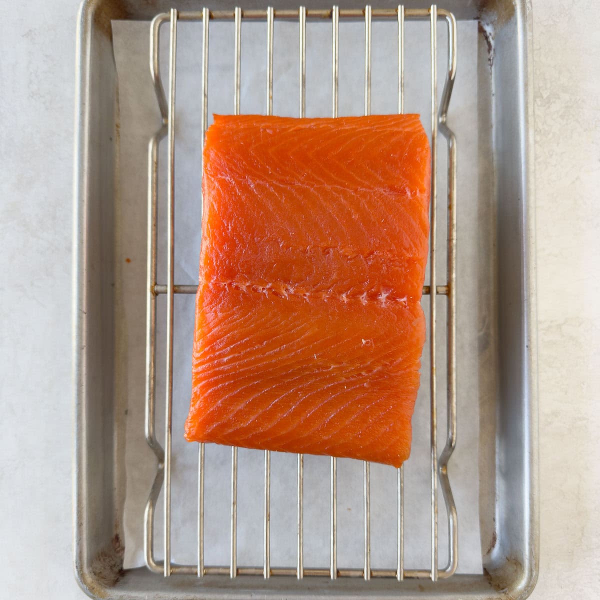 Salmon fillet on a wire rack after drying and formation of the pellicle.