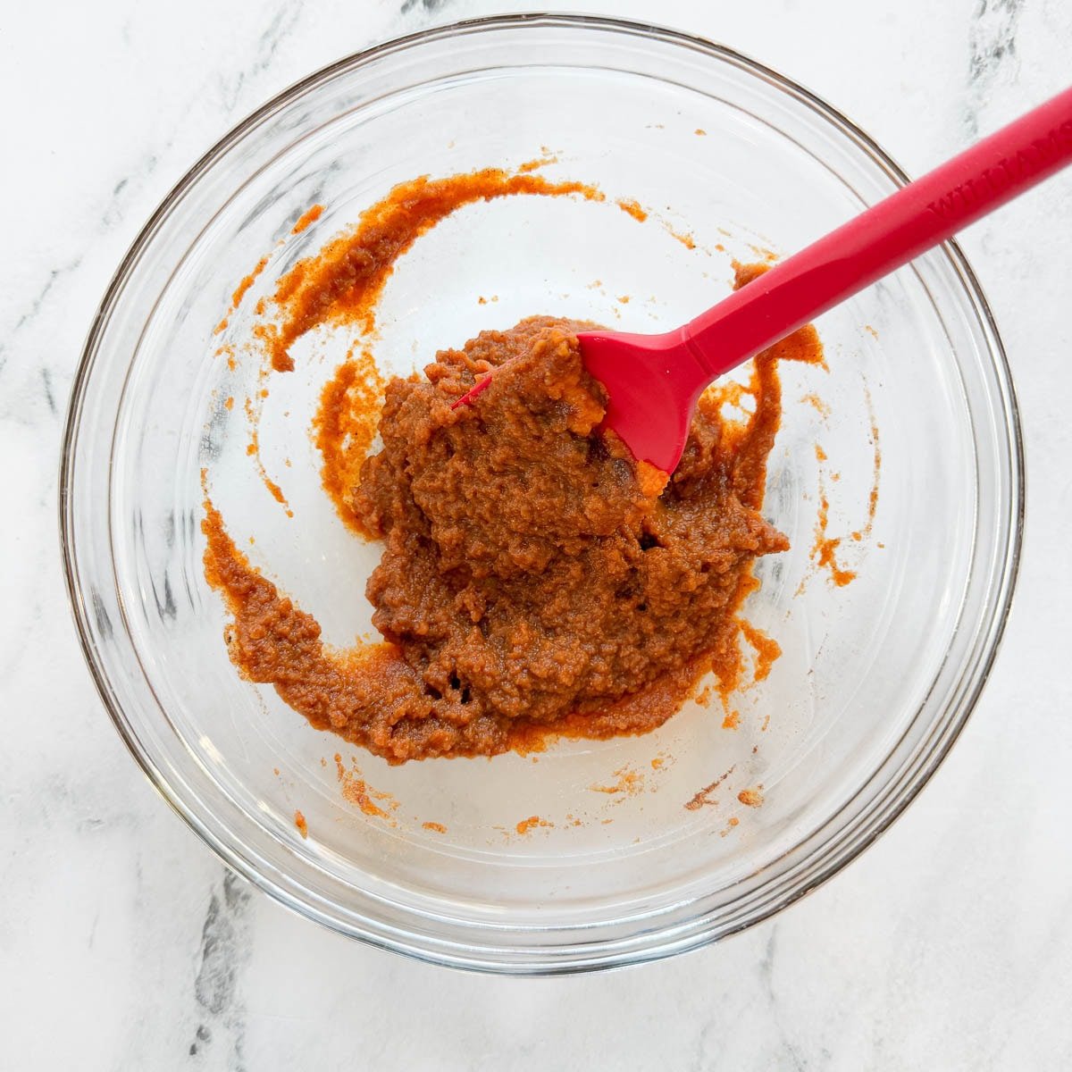 Mixing pumpkin, spices, and maple into a paste for overnight oats base.