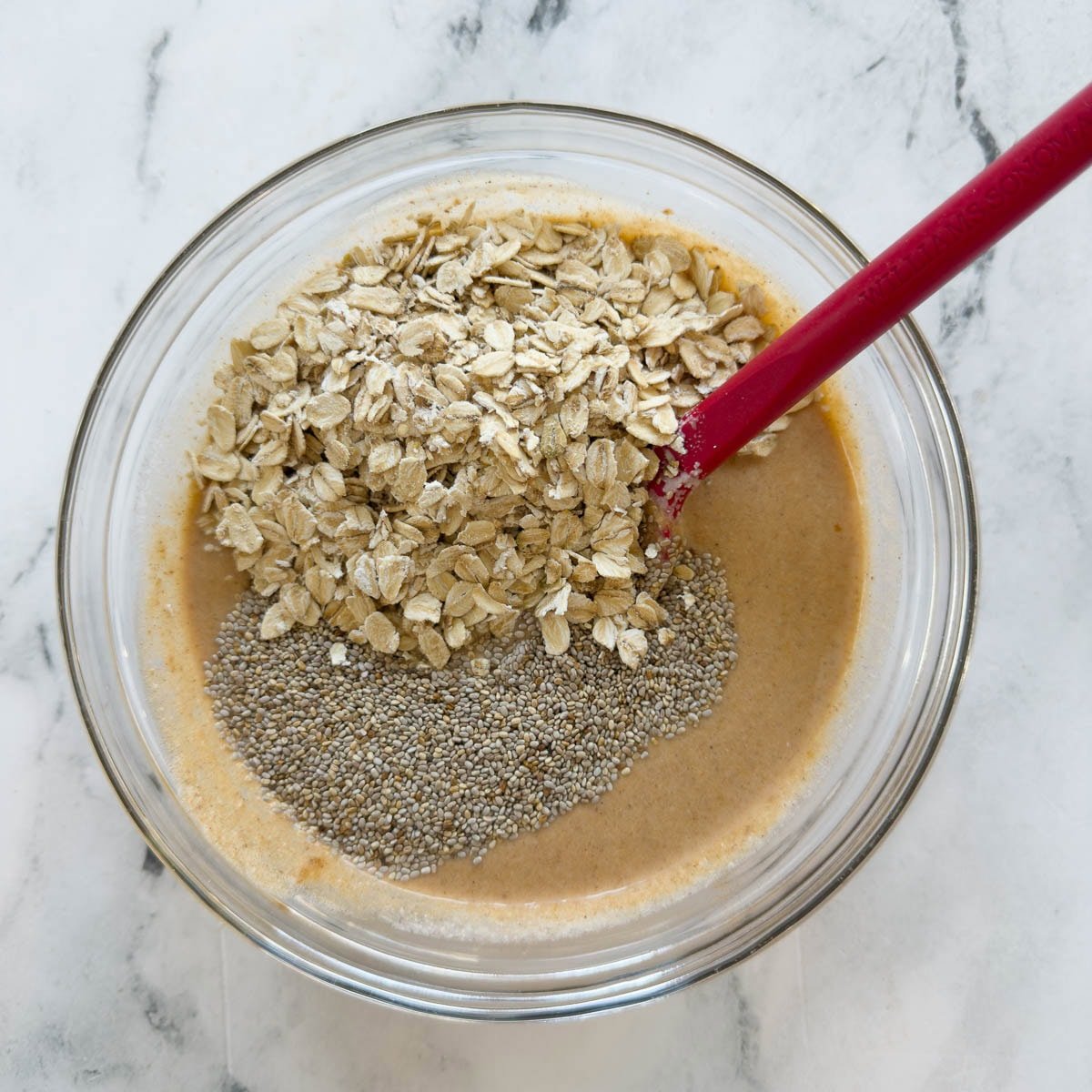 Overnight pumpkin oats base with chia seeds in a glass bowl.