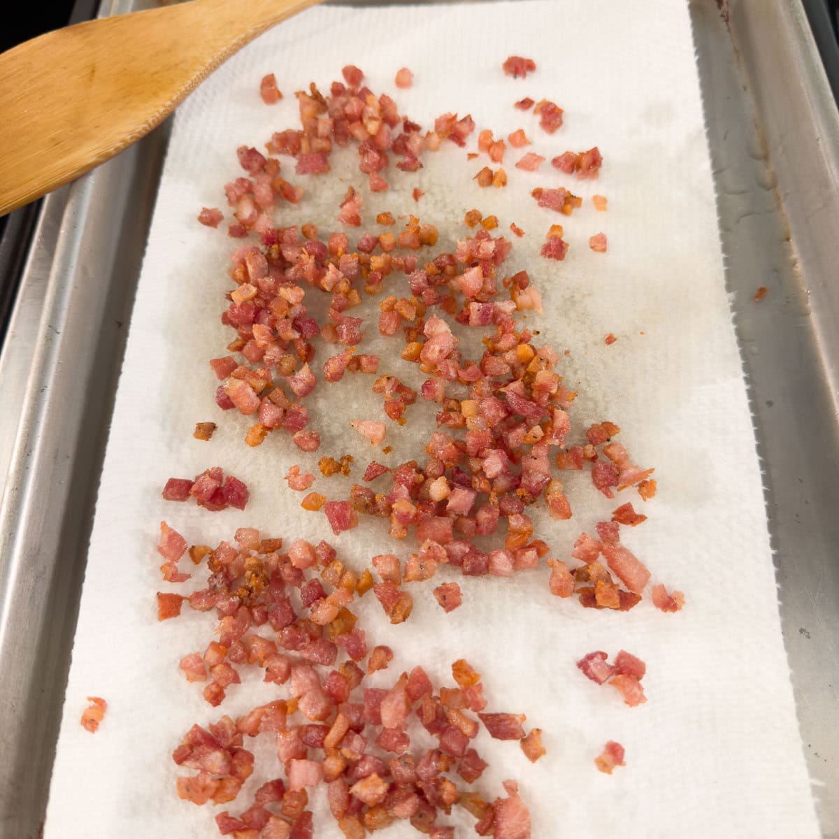 With slotted spoon, remove the pancetta to a plate or tray line with paper towels to drain excess fat. 