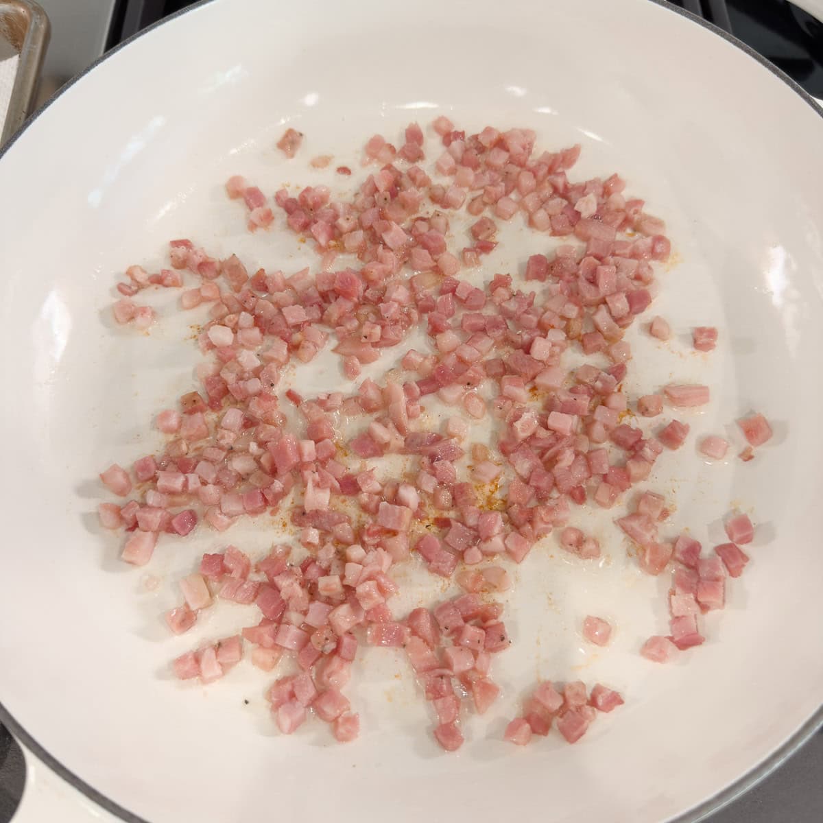 Brown the diced pancetta in a wide shallow pan until crisp and most fat has rendered out. 
