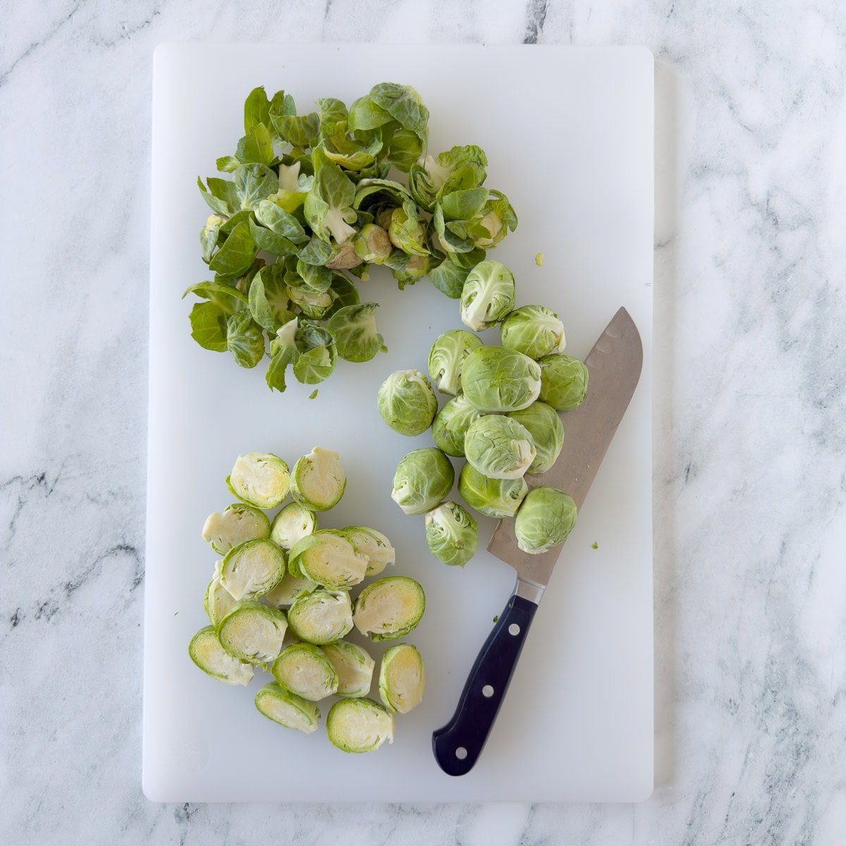 Trimming and cutting Brussels sprouts prepping for cooking.