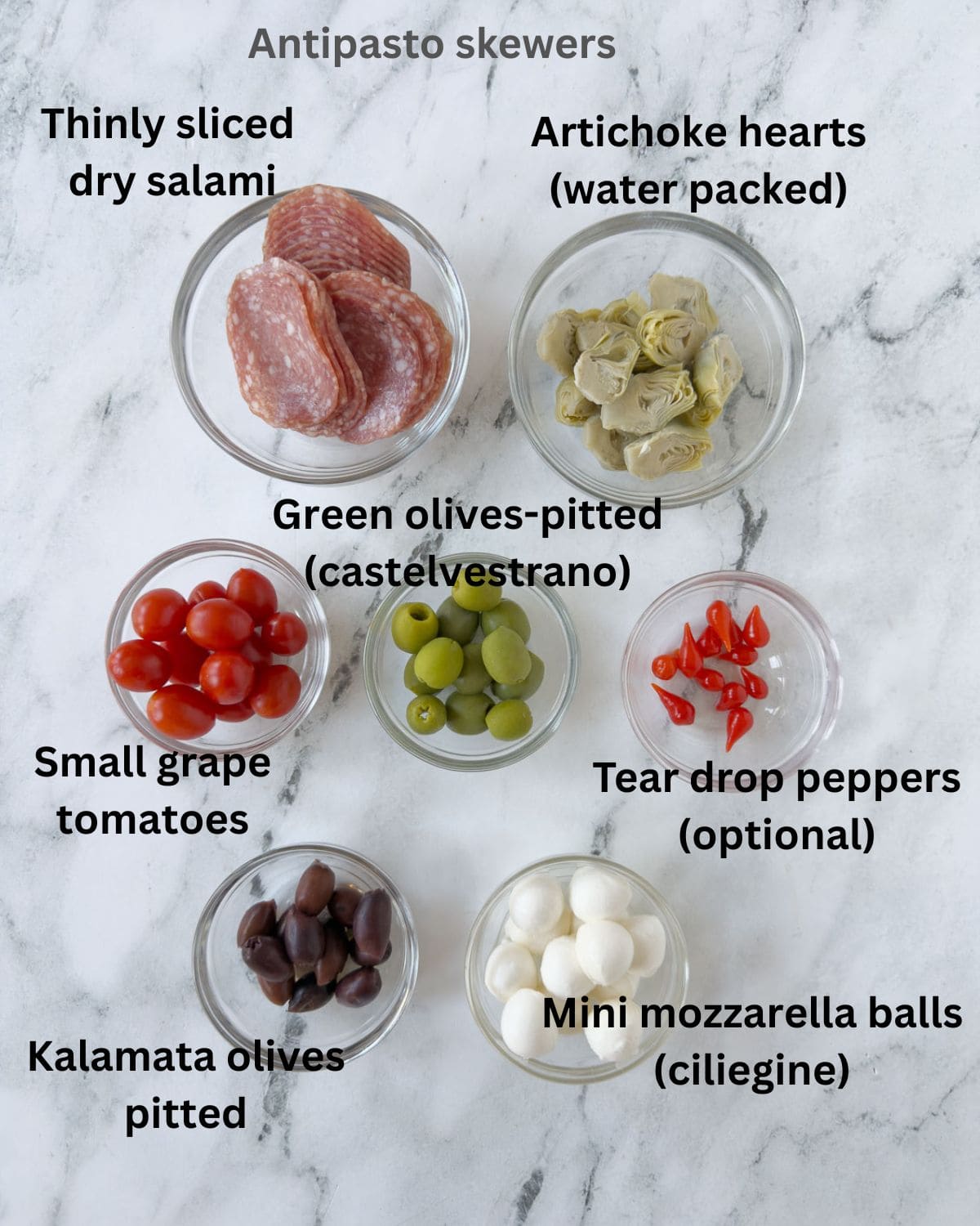 Ingredients for antipasto skewers in prep bowls ready for assembly.