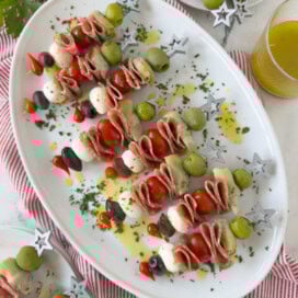 A platter of antipasto skewers with olives, cheese, salami, and artichoke heart for appetizers.