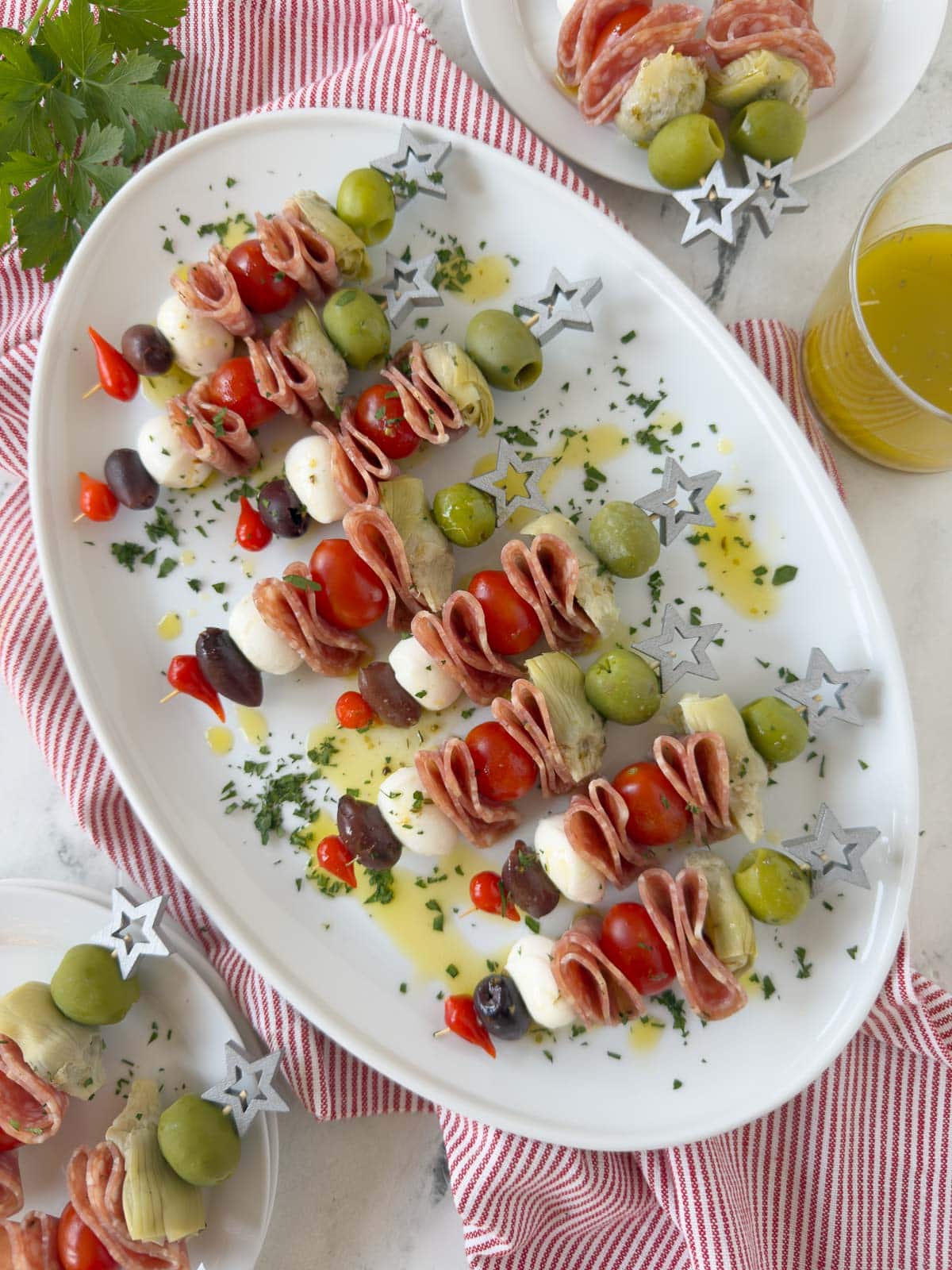 Colorful antipasto skewers on fancy star-topped picks drizzled with Italian dressing.