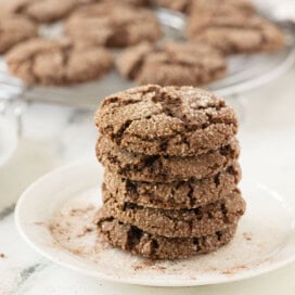 Chocolate almond cookies with crinkled tops and sugar sprinkles.