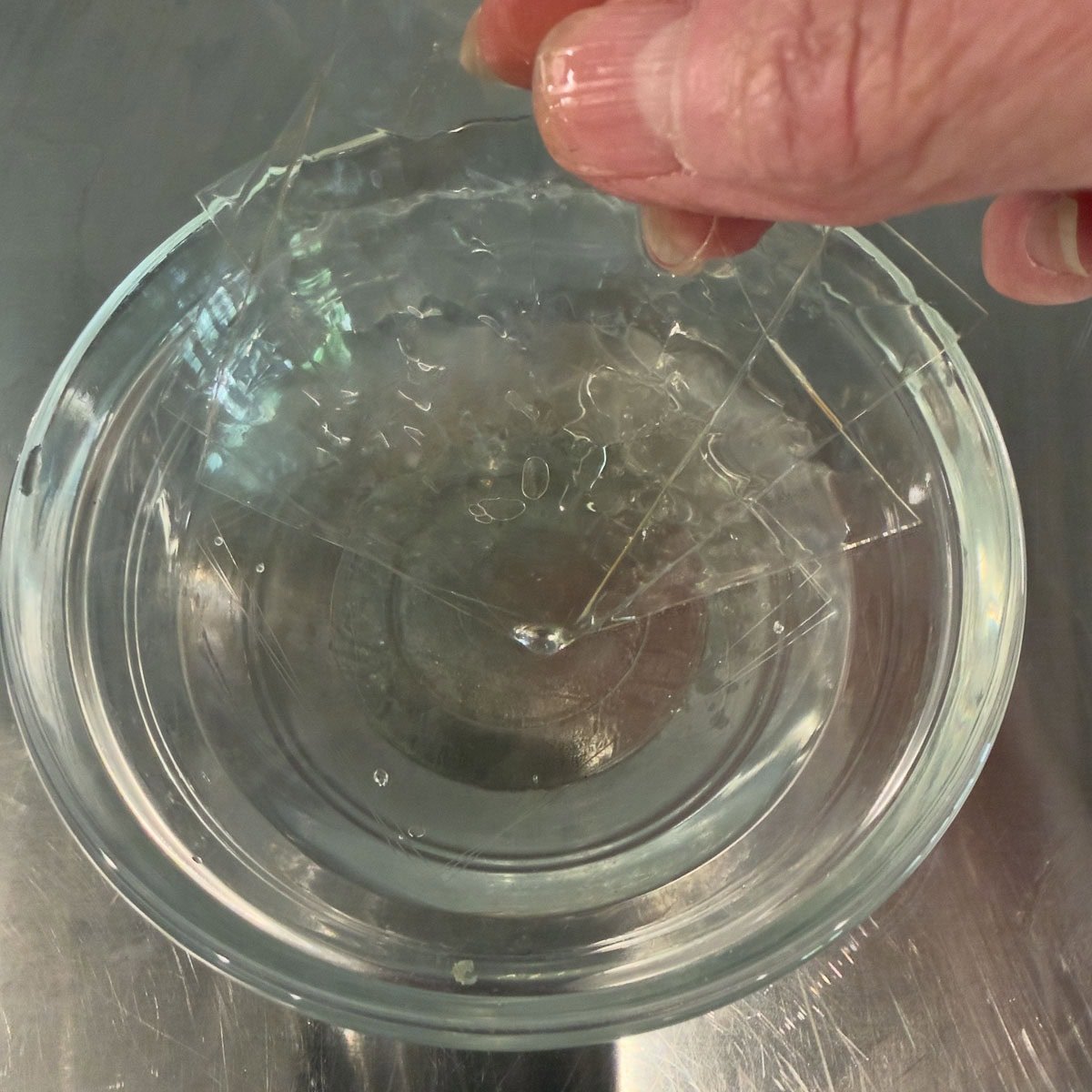Soaking leaf gelatin in cold water to soften.