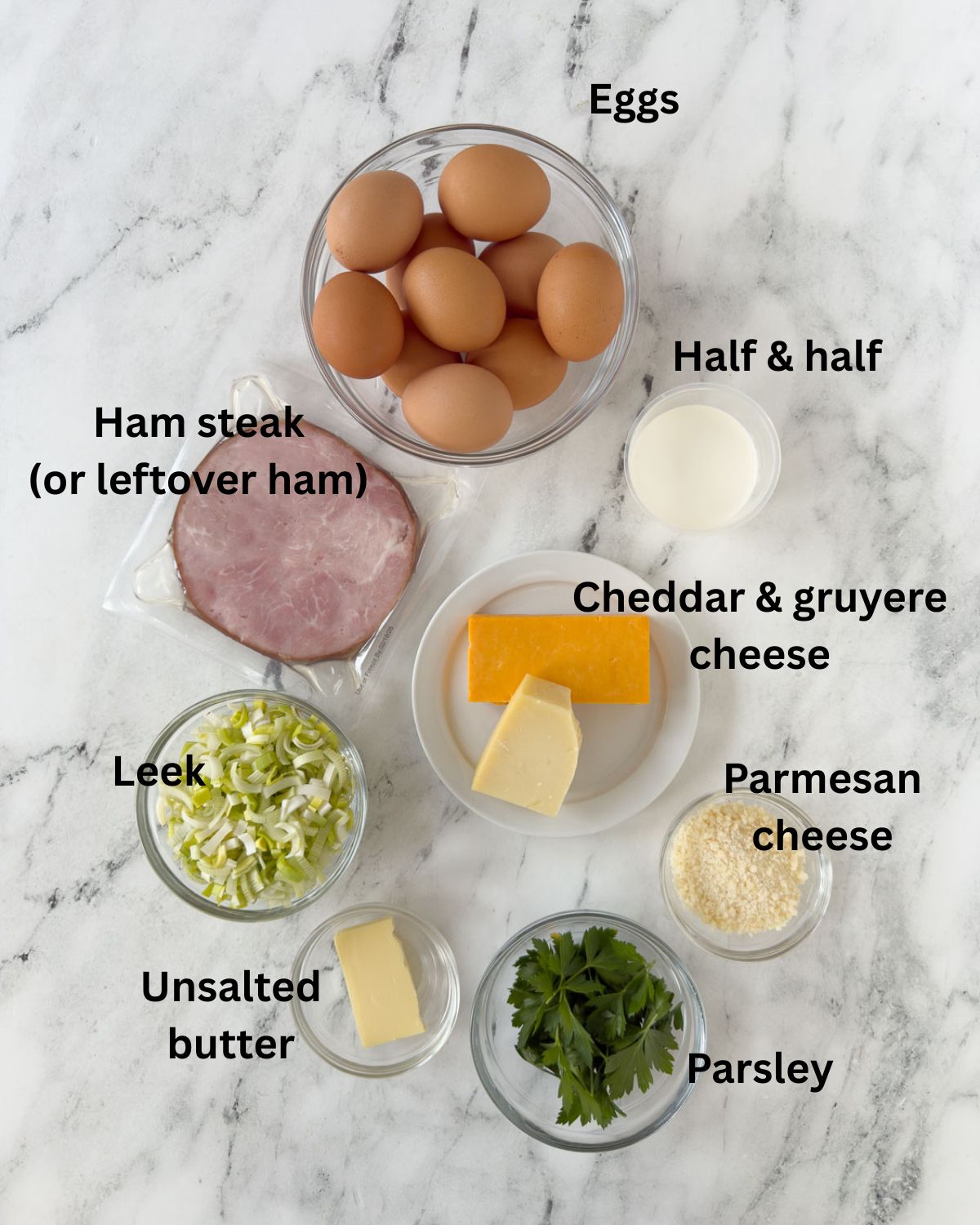 Ham and cheese frittata ingredients in prep bowls on a counter.