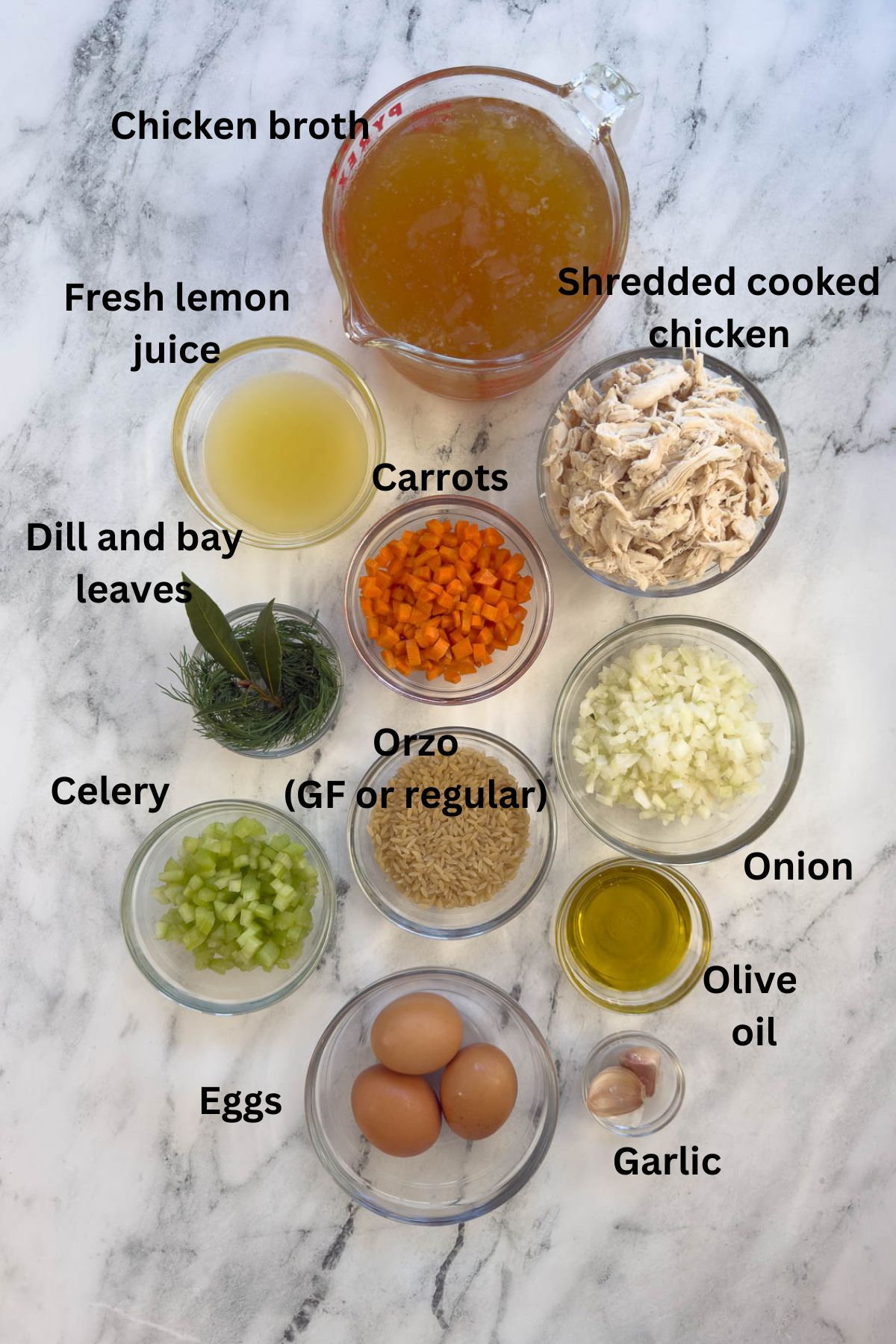 Ingredients for Greek avgolemono soup in prep bowls on the counter.