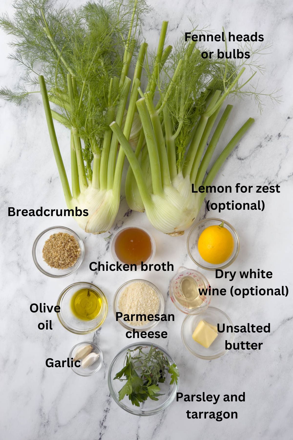 Fennel bulbs with fronds, oil, lemon, butter, herbs, parmesan to make a brasied fennel side dish.