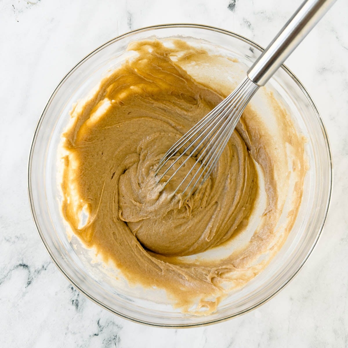 Combining wet and dry ingredients to make cinnamon muffin batter.