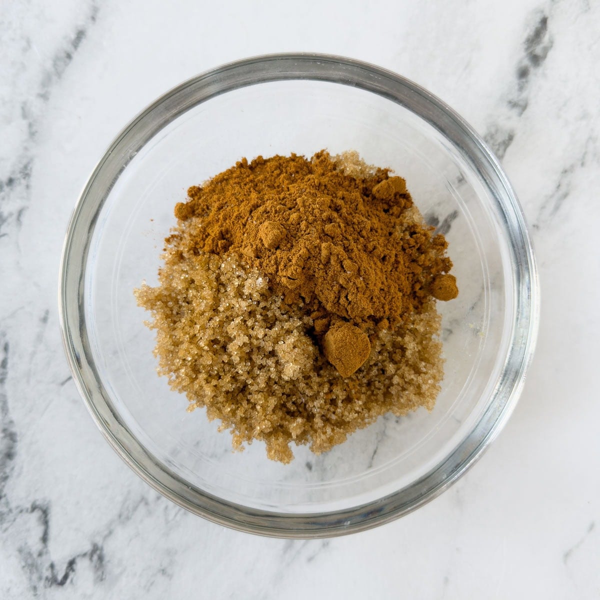 Brown sugar and cinnamon mixed in a small bowl for muffins.