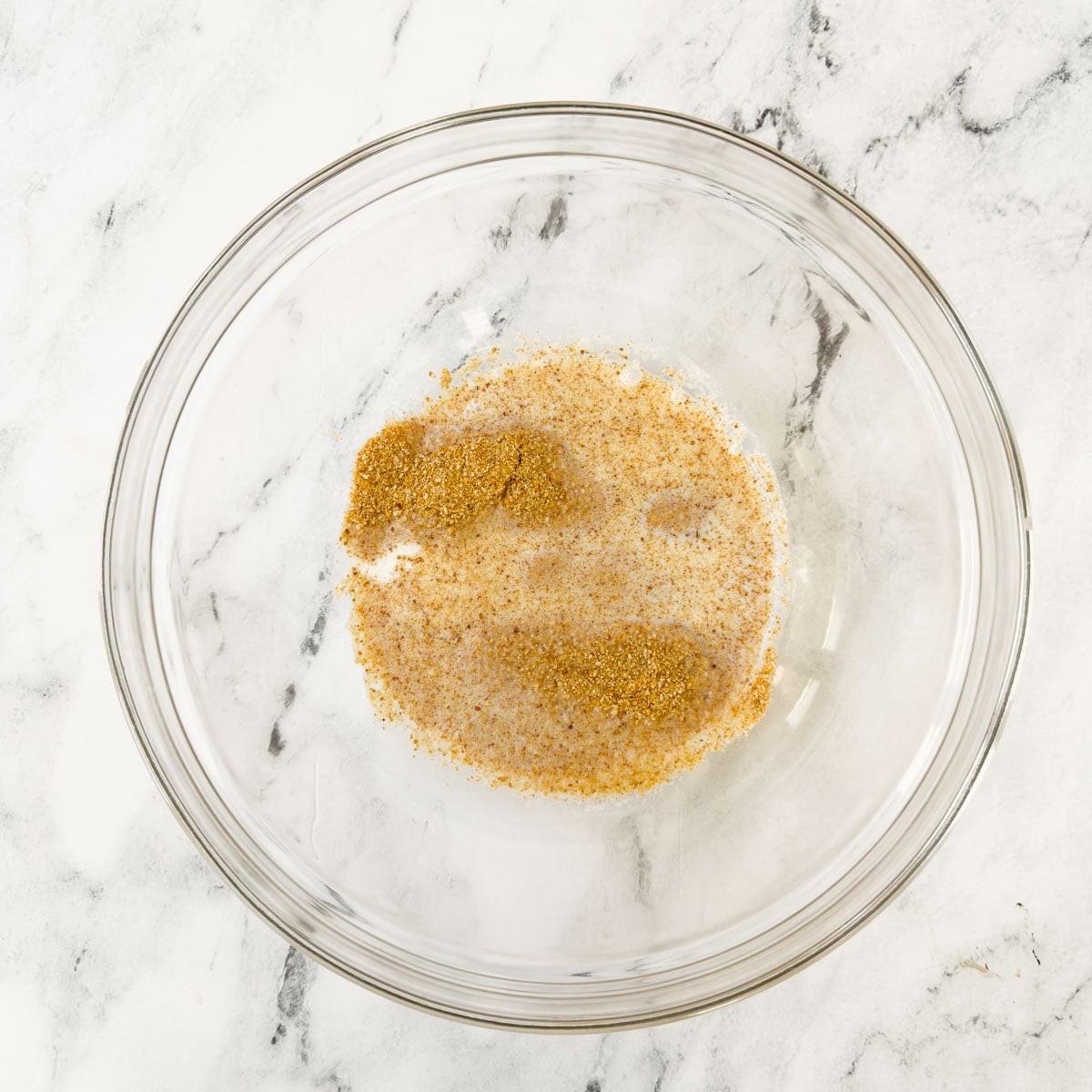 A mix of breadcrumbs and milk, a binder for chicken meatballs, in a bowl.