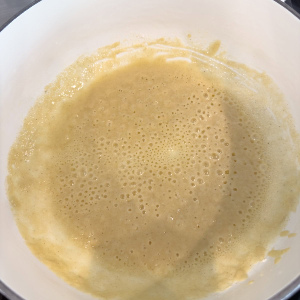 The start of a roux to thicken make a béchamel sauce, flour and butter in a pan.