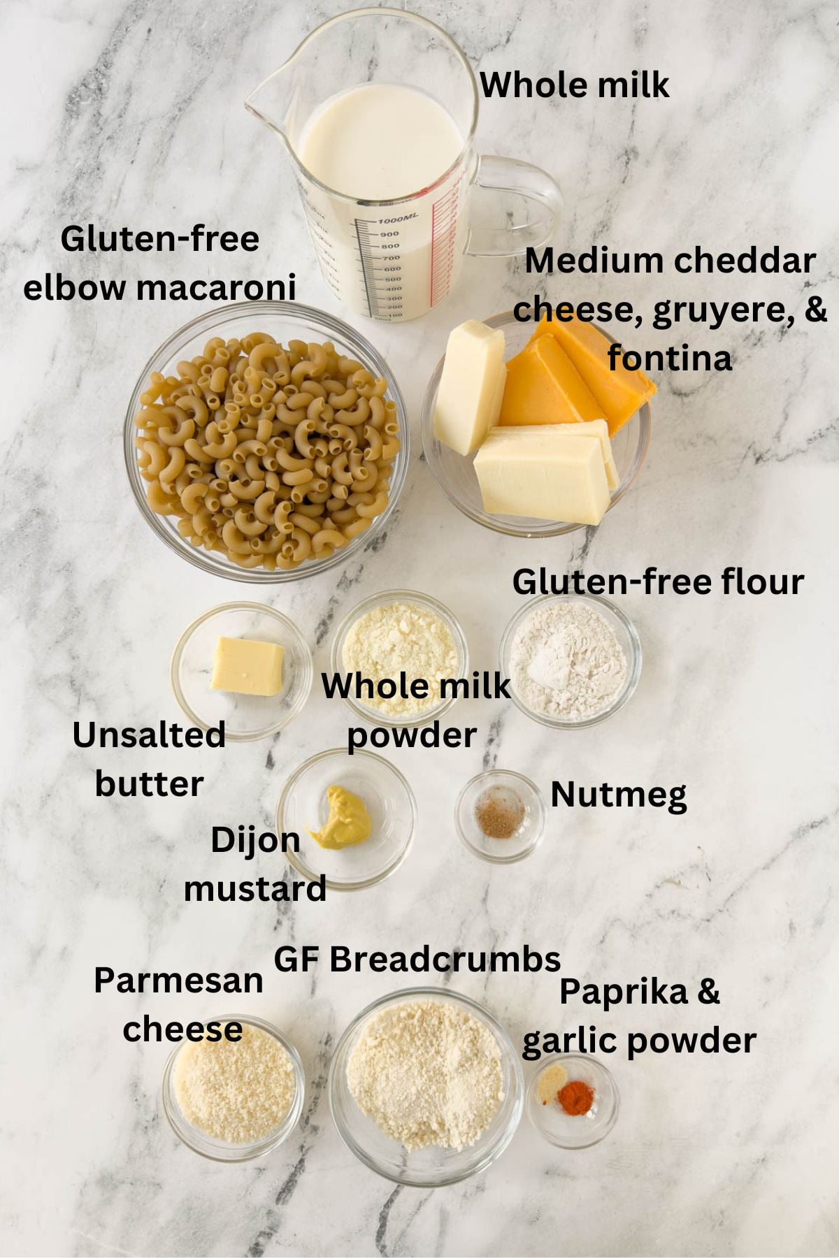 Ingredients for gluten-free mac and cheese in prep bowls on a kitchen counter.