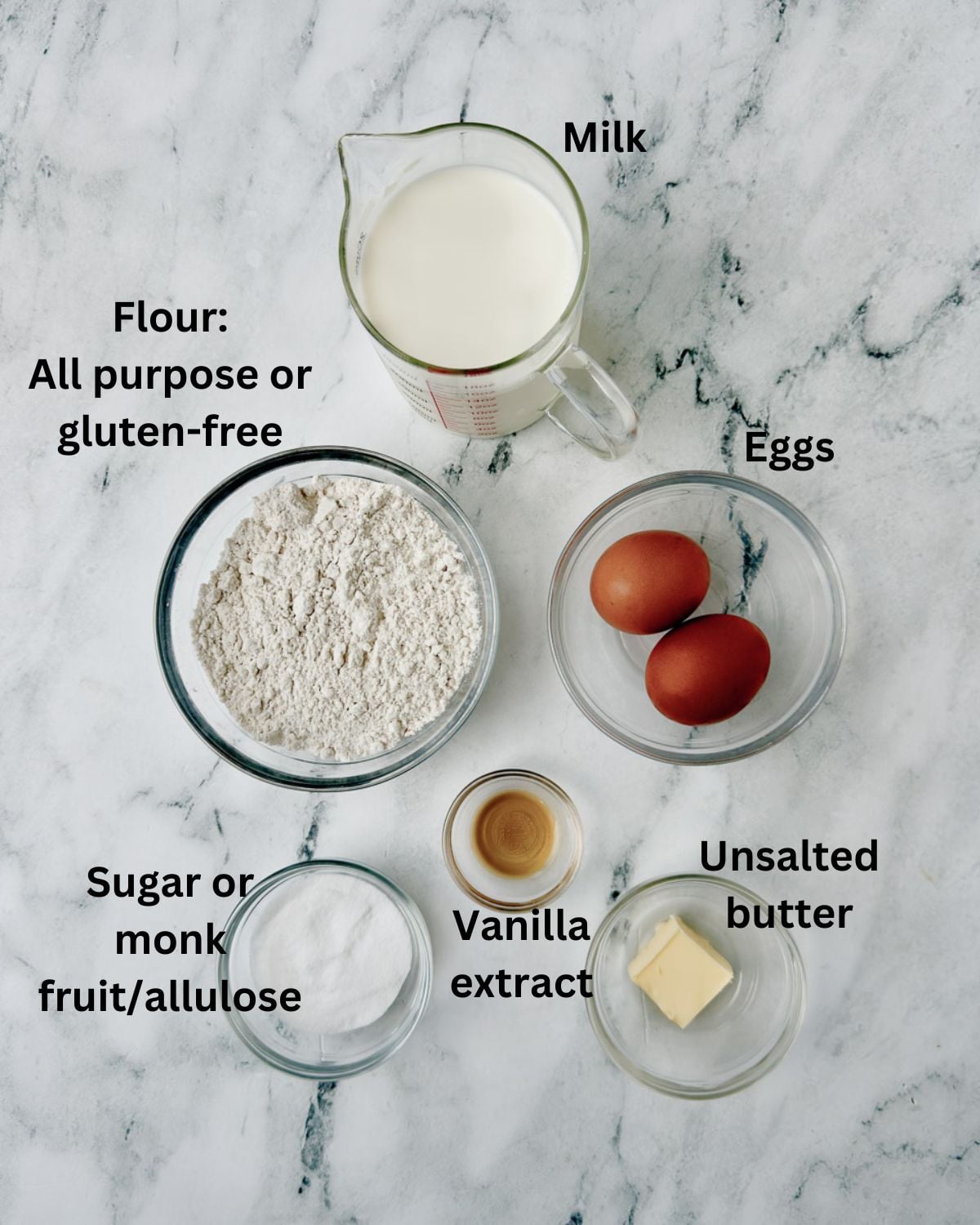 Ingredients for crepe in prep bowls on the counter.