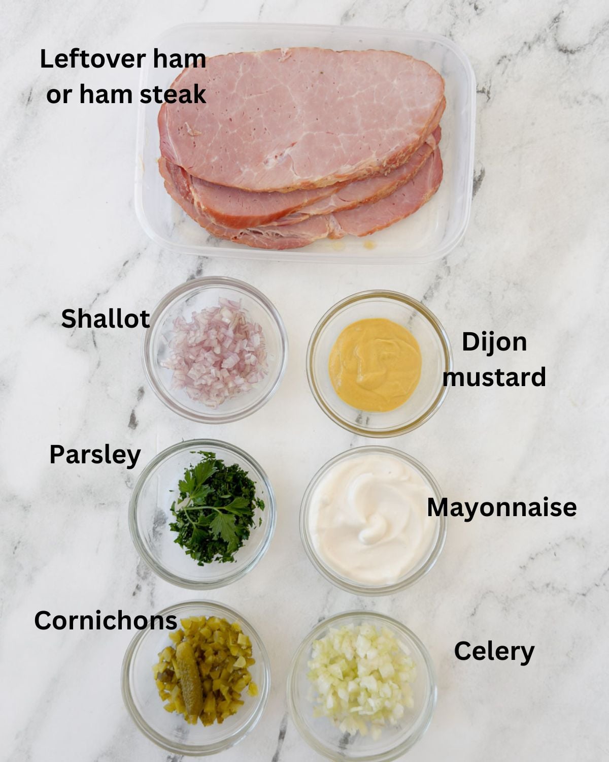 Ingredients for a ha salad in prep bowls on a counter.
