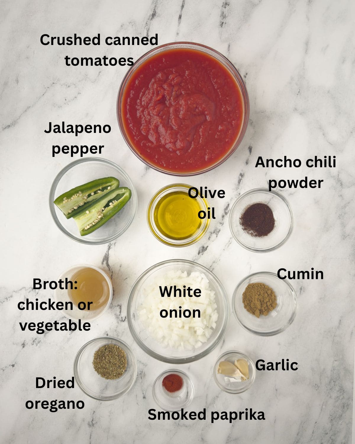 Ingredients for Mexican Ranchero Sauce with tomatoes, peppers, spices, onion, and more.