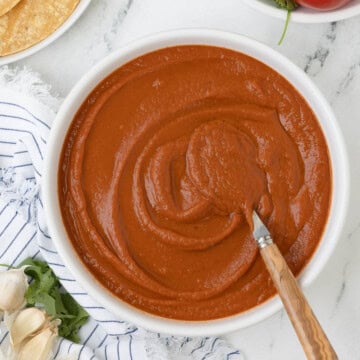 based Mexican ranchero sauce in a bowl with a wood spoon.