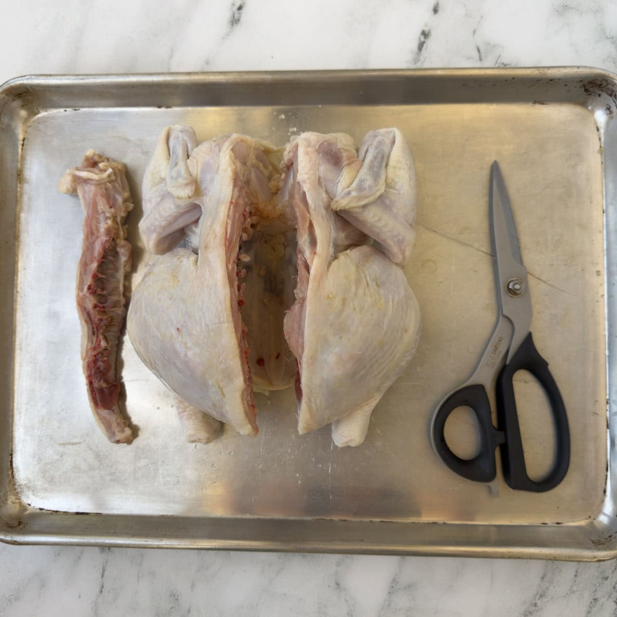 Whole chicken with the backbone cut out, called spatchcock chicken.