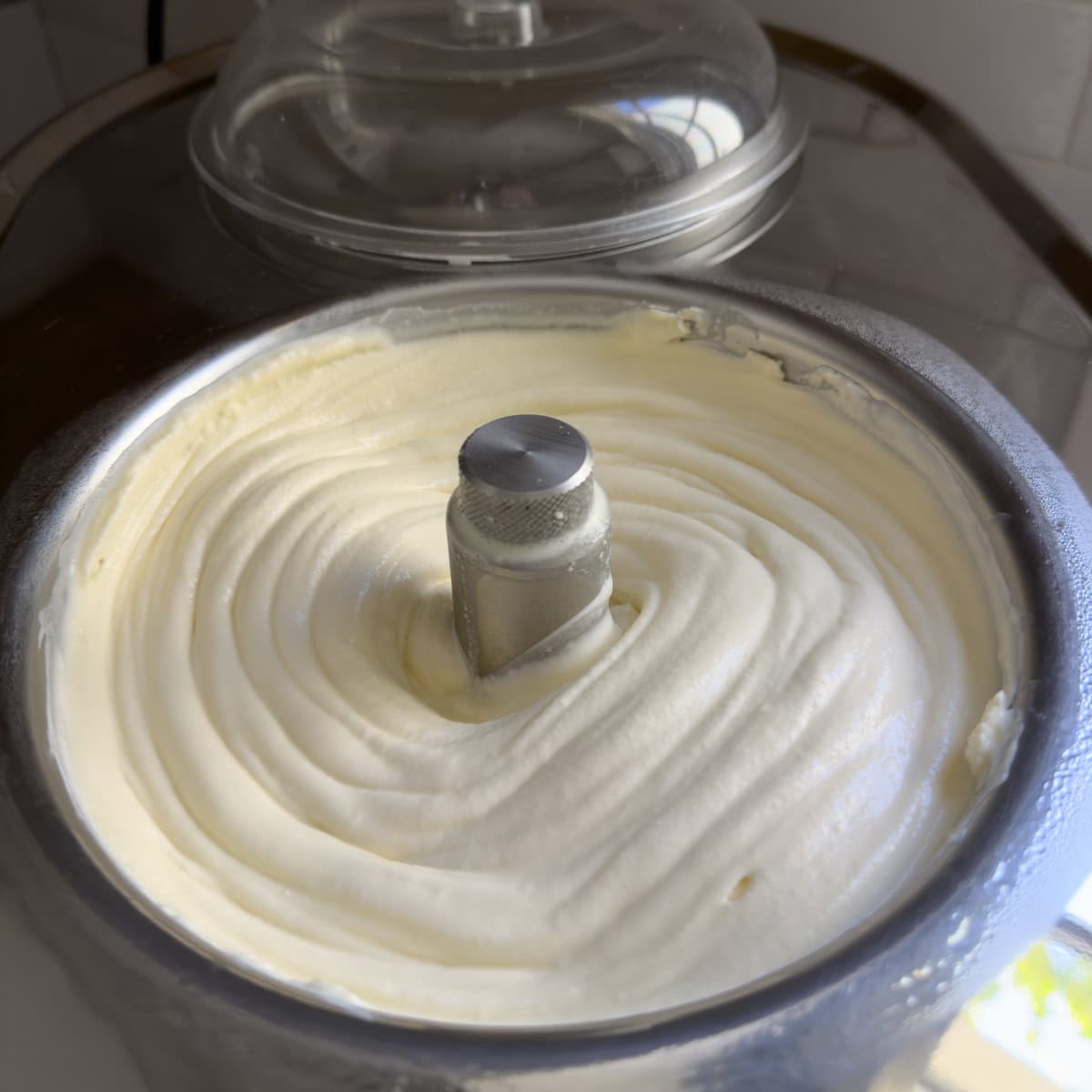 Swirls of cheesecake ice cream done churning in an ice cream maker.