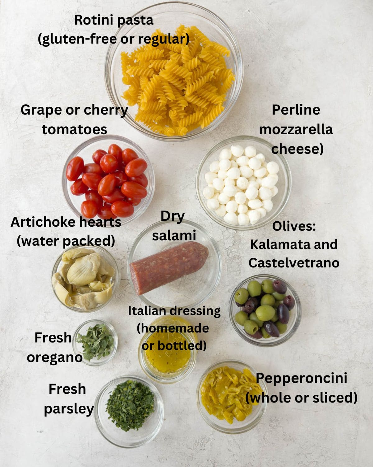 Antipasto salad ingredients in prep bowls ready to go.