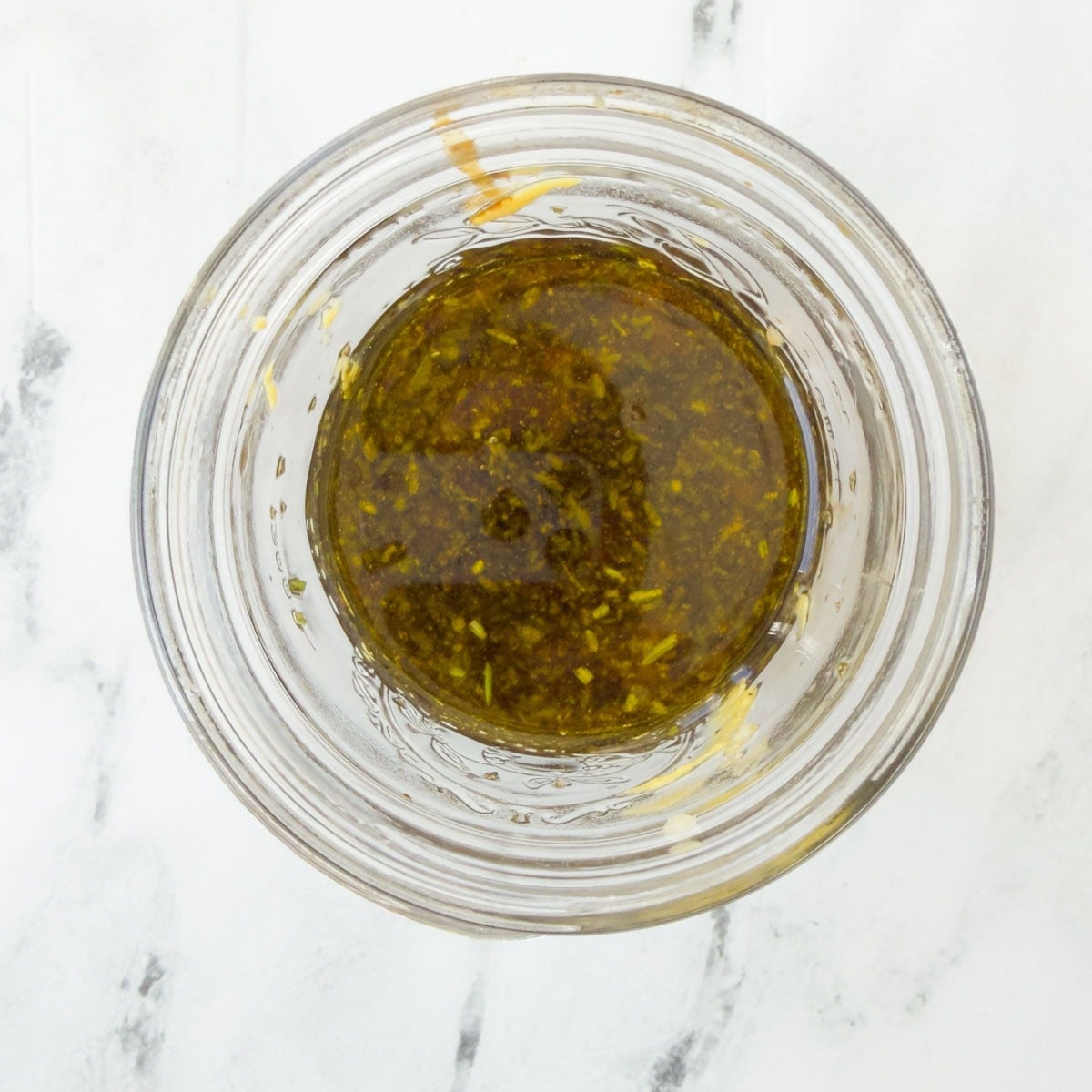 Ingredients for flank steak marinade in a glass jar.