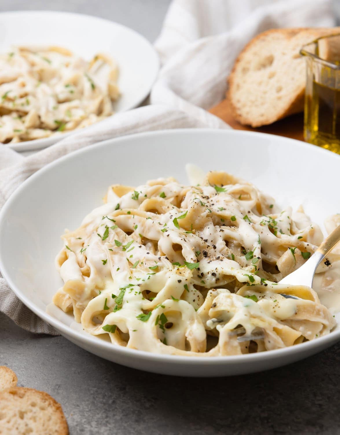 A bowl of fettuccine alfredo made with cottage cheese and parmesan, with parsley.