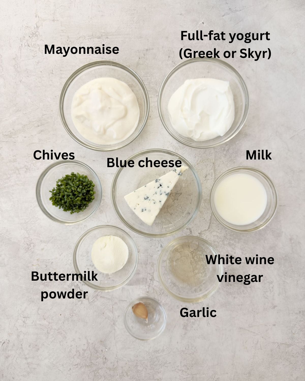 Ingredients for a yogurt blue cheese dressing in prep bowls.