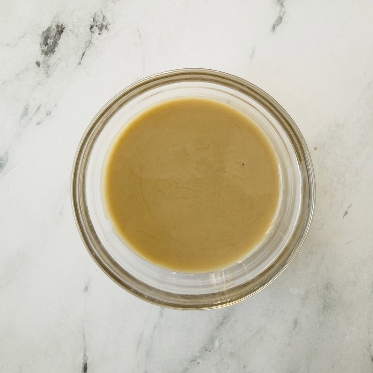 A jar of creamy smooth sesame ginger dressing.